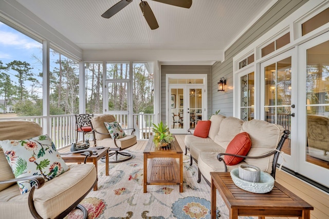 sunroom / solarium featuring ceiling fan and french doors