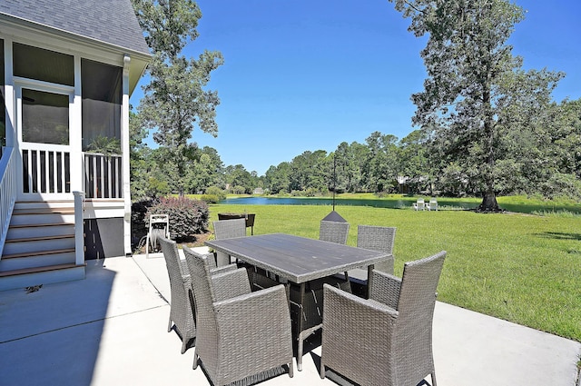 view of patio / terrace with outdoor dining space and a water view