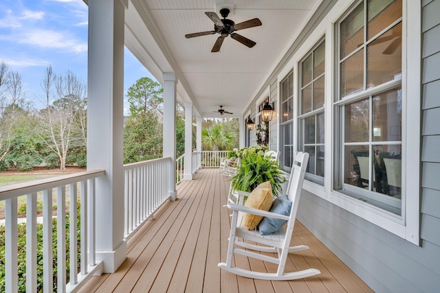 deck featuring covered porch and ceiling fan