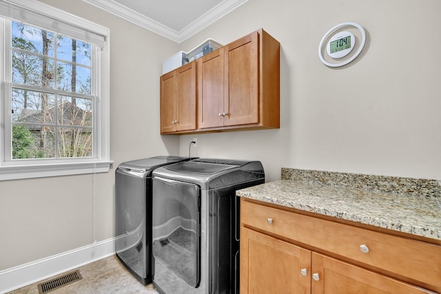 clothes washing area with light tile patterned floors, cabinet space, visible vents, ornamental molding, and washer and dryer