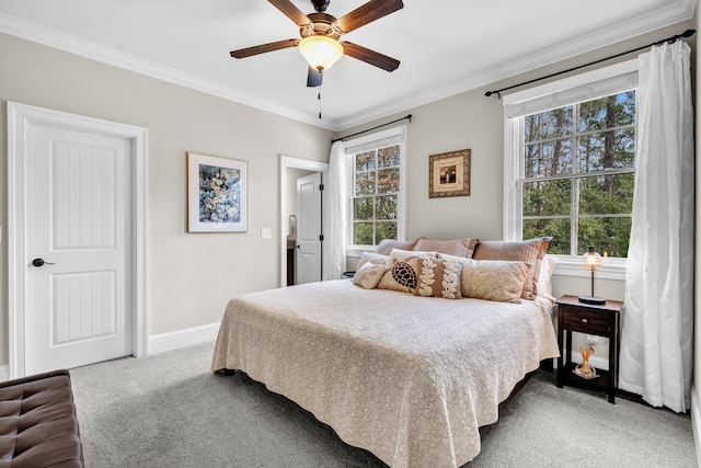 bedroom featuring carpet flooring, crown molding, baseboards, and ceiling fan