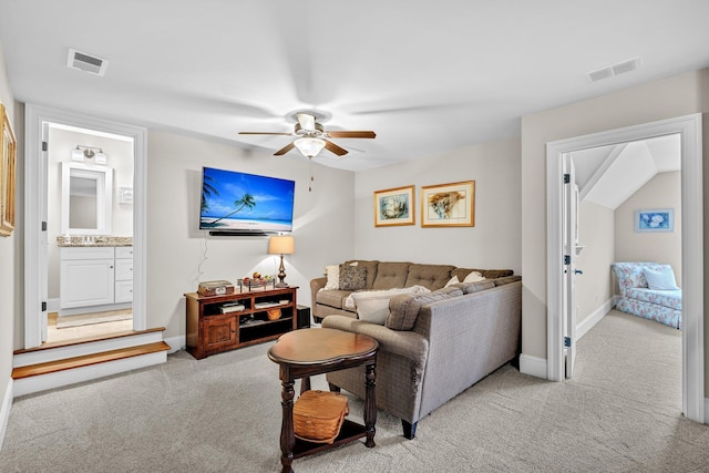 living room with light carpet, baseboards, and visible vents