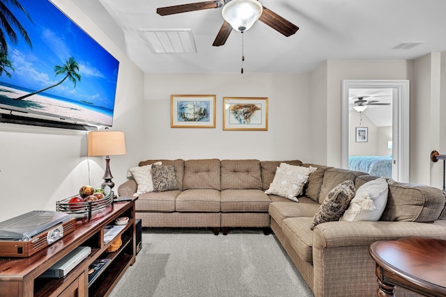 living room with lofted ceiling, carpet, visible vents, and a ceiling fan