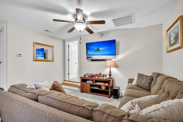 carpeted living room with visible vents and ceiling fan