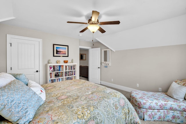 carpeted bedroom with baseboards, vaulted ceiling, and a ceiling fan