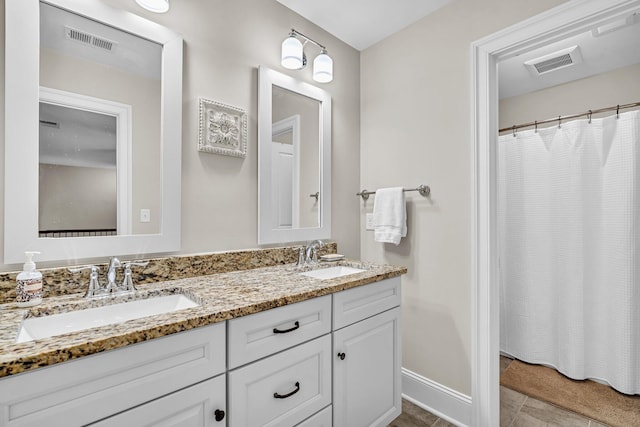 full bathroom with visible vents, a sink, and double vanity