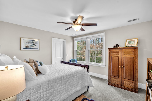 bedroom featuring ceiling fan, carpet floors, visible vents, and baseboards