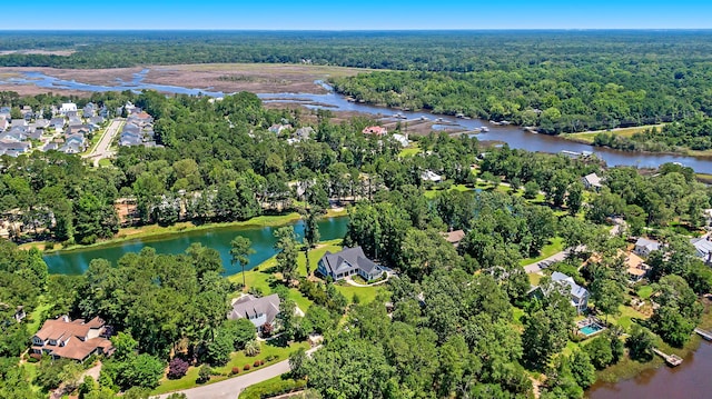 drone / aerial view featuring a water view and a wooded view