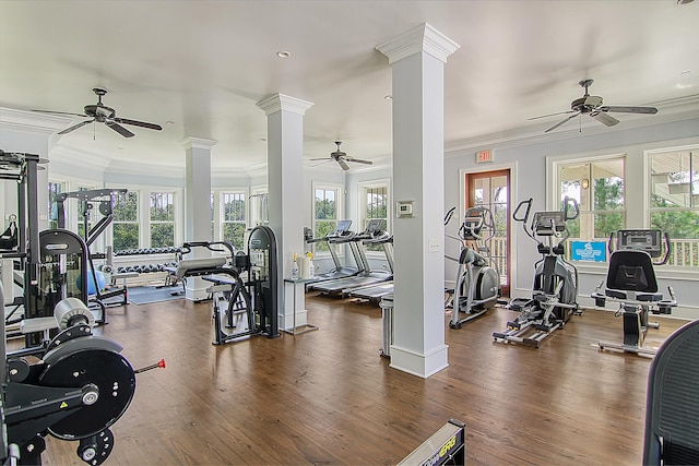 workout area with decorative columns, crown molding, a ceiling fan, and wood finished floors