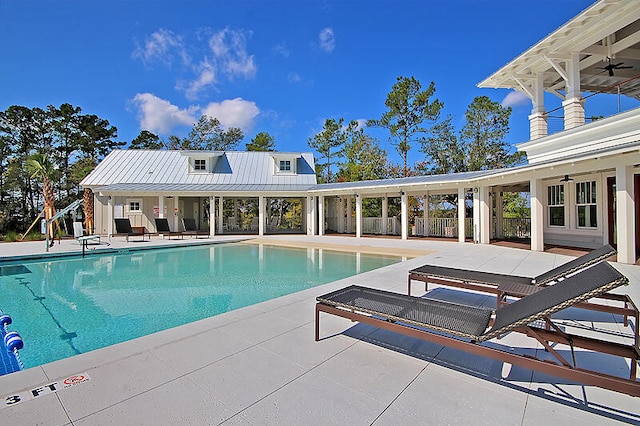 pool featuring a patio, fence, and a ceiling fan