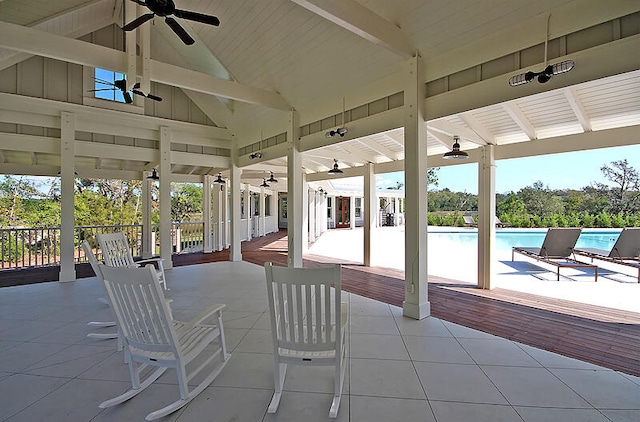 view of patio / terrace with an outdoor pool and a ceiling fan