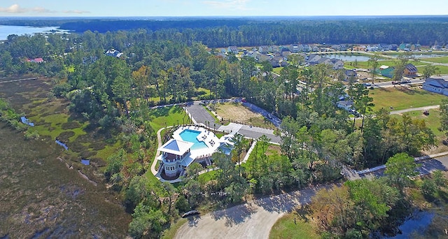 drone / aerial view featuring a water view and a forest view