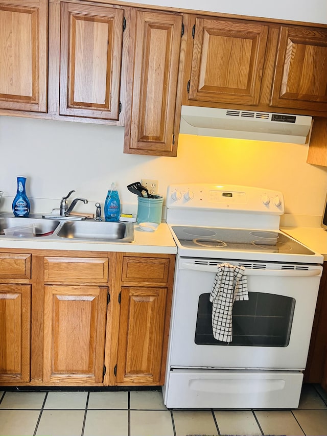 kitchen featuring white electric range oven, sink, light tile patterned floors, and extractor fan