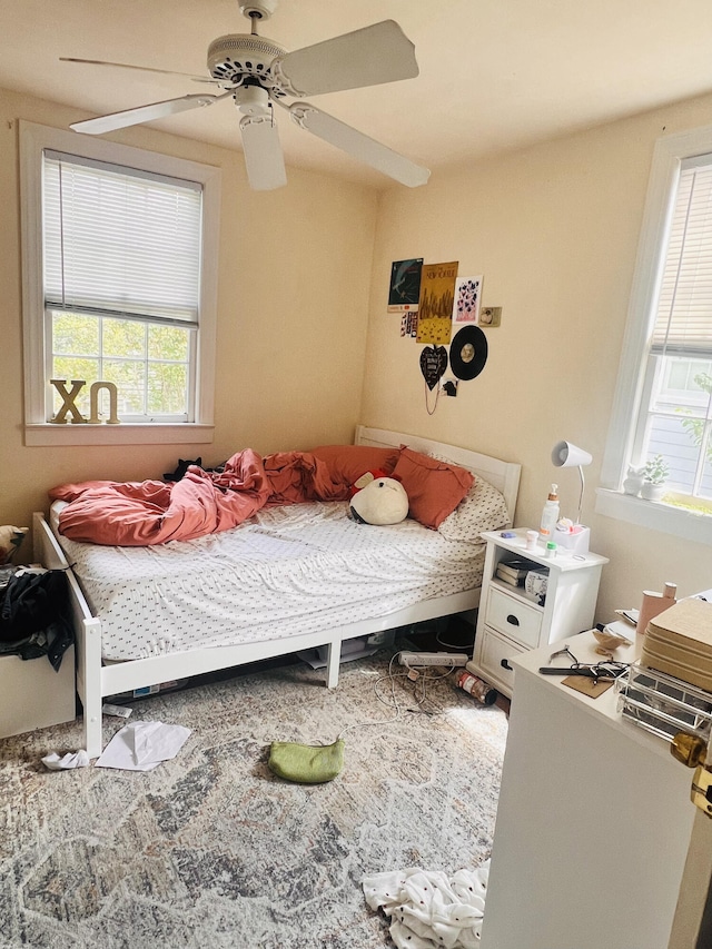 bedroom featuring ceiling fan and multiple windows