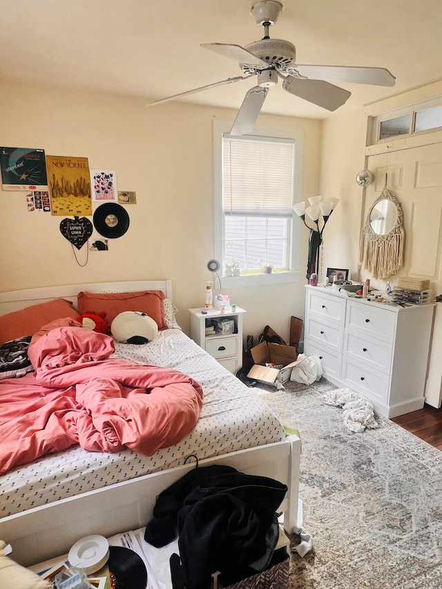 bedroom with dark hardwood / wood-style floors and ceiling fan