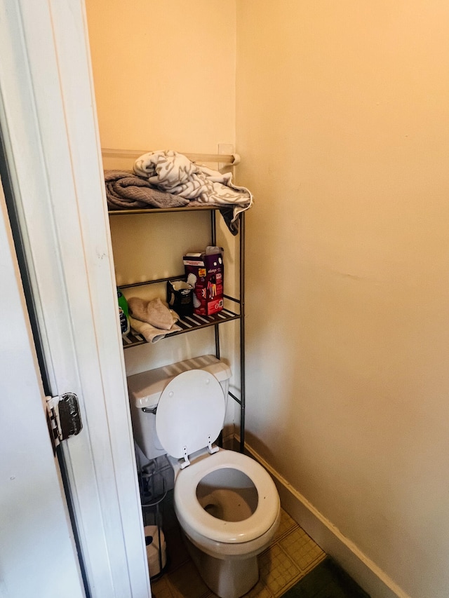 bathroom featuring toilet and tile patterned floors