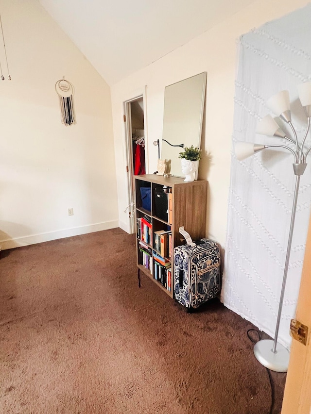 interior space featuring lofted ceiling and carpet floors