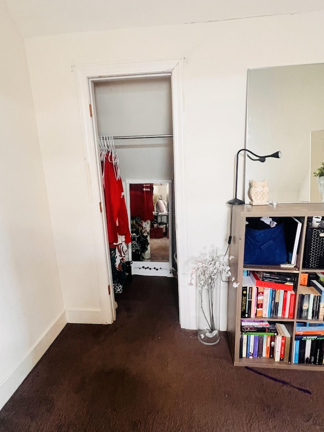 corridor with dark colored carpet