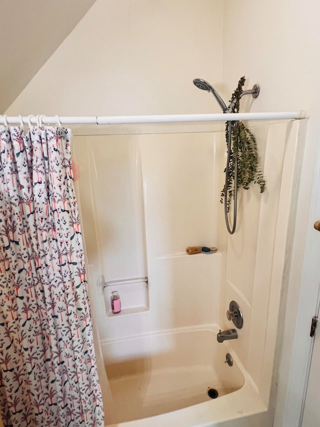 bathroom with shower / bath combo with shower curtain