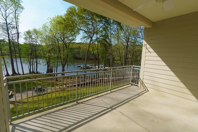 balcony with a ceiling fan and a water view