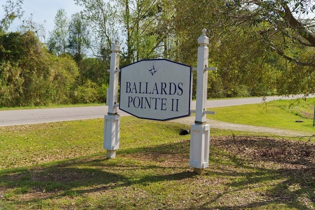 community sign featuring a lawn