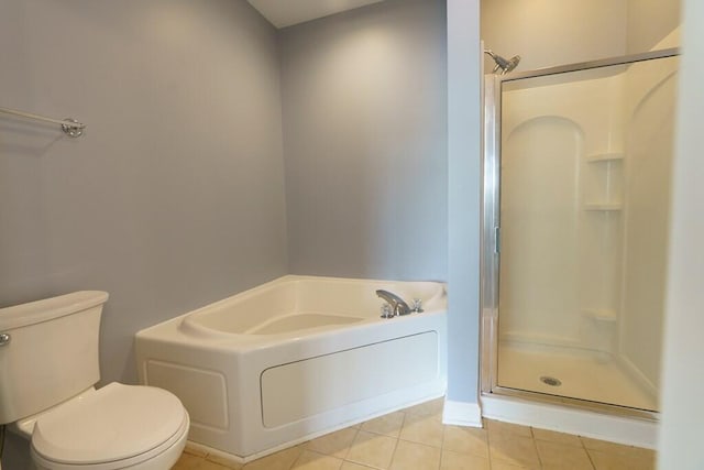 full bath featuring a shower stall, tile patterned flooring, a garden tub, and toilet