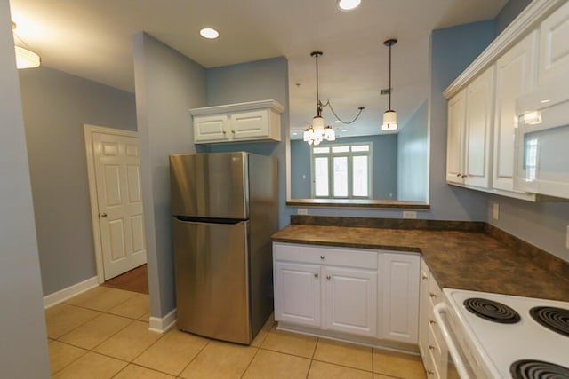 kitchen featuring white appliances, white cabinets, a chandelier, light tile patterned flooring, and dark countertops
