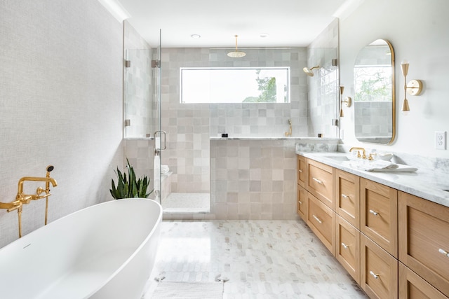 bathroom with vanity and shower with separate bathtub