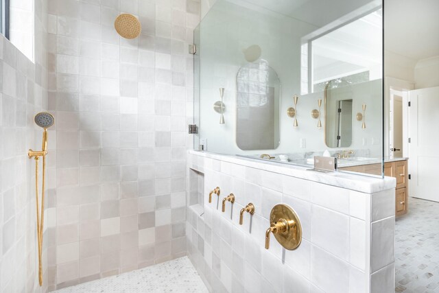 bathroom featuring sink and a tile shower