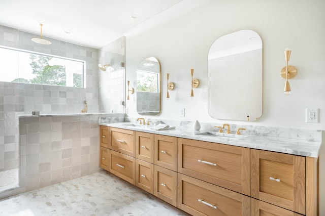 bathroom with vanity, a wealth of natural light, tile patterned flooring, and tiled shower