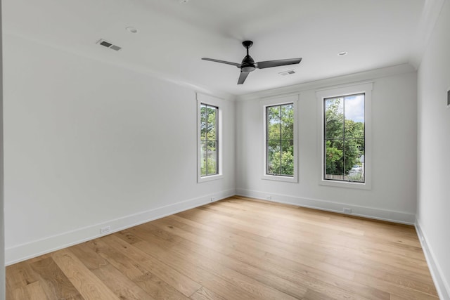 unfurnished room featuring ceiling fan, light wood-type flooring, and crown molding