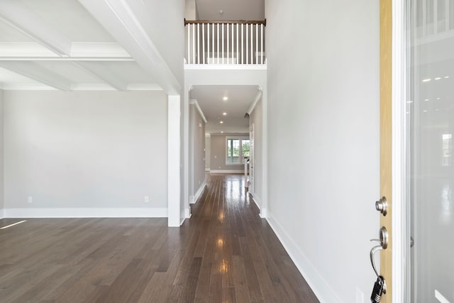 foyer with beam ceiling and dark hardwood / wood-style flooring