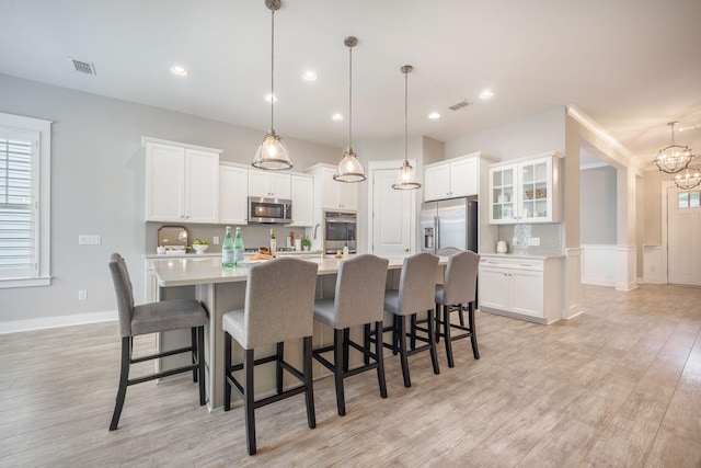 331 Fish Creek Ct, Summerville, SC 29486 - kitchen featuring appliances with stainless steel finishes, light wood finished floors, light countertops, tasteful backsplash, and recessed lighting