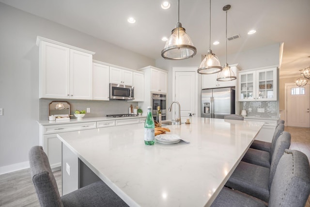 331 Fish Creek Ct, Summerville, SC 29486 - kitchen featuring appliances with stainless steel finishes, a sink, decorative backsplash, light countertops, and white cabinets