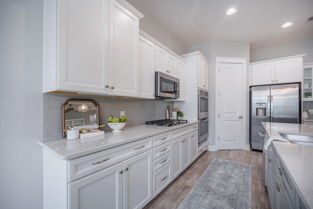 331 Fish Creek Ct, Summerville, SC 29486 - kitchen featuring appliances with stainless steel finishes, white cabinetry, backsplash, light wood-type flooring, and recessed lighting