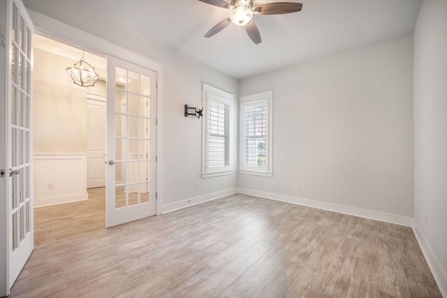 331 Fish Creek Ct, Summerville, SC 29486 - spare room featuring french doors, a chandelier, light wood finished floors, a ceiling fan, and baseboards
