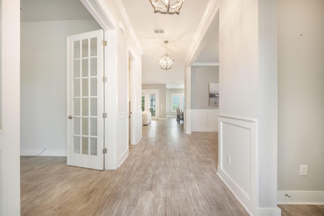 331 Fish Creek Ct, Summerville, SC 29486 - hall with a chandelier, light wood-style floors, wainscoting, and a decorative wall