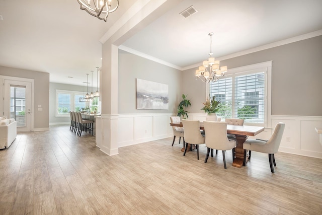 331 Fish Creek Ct, Summerville, SC 29486 - dining area with a chandelier, a decorative wall, light wood finished floors, wainscoting, and ornamental molding