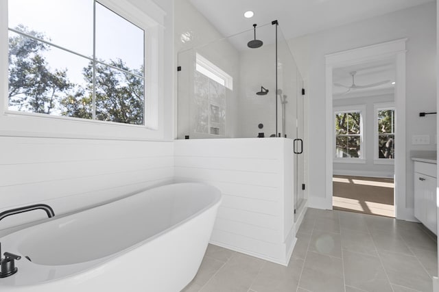 bathroom featuring vanity, tile patterned floors, and shower with separate bathtub