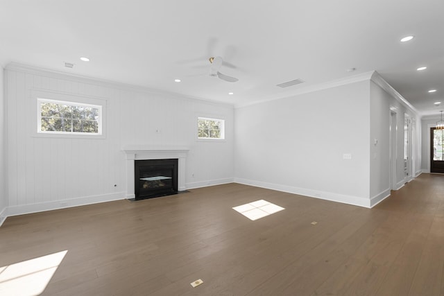 unfurnished living room featuring ornamental molding, dark wood-type flooring, and ceiling fan