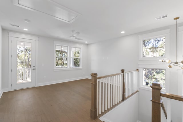 corridor with dark hardwood / wood-style flooring