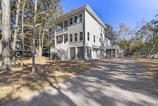 view of side of home featuring a balcony and covered porch