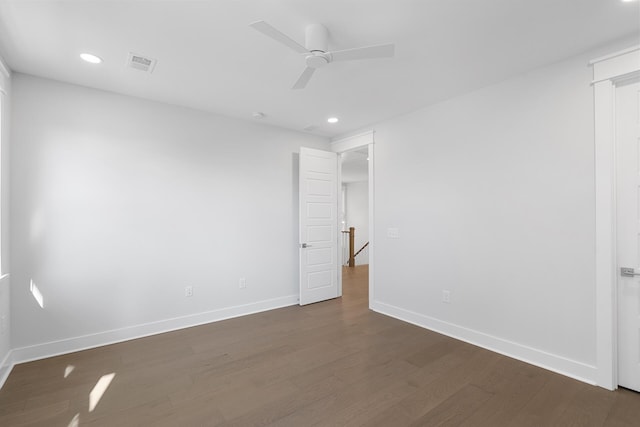 empty room with dark wood-type flooring and ceiling fan