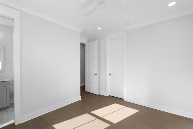 unfurnished bedroom featuring crown molding, ceiling fan, ensuite bathroom, and dark hardwood / wood-style floors