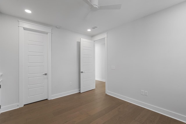 unfurnished bedroom featuring ceiling fan and dark hardwood / wood-style flooring