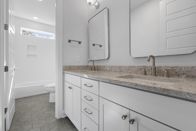 full bathroom with tiled shower / bath combo, vanity, tile patterned floors, and toilet