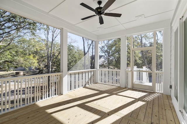 unfurnished sunroom featuring ceiling fan