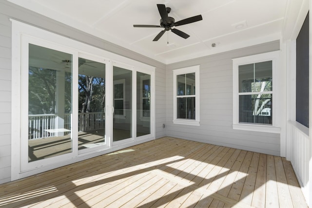 unfurnished sunroom with ceiling fan