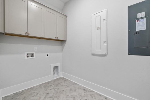 washroom featuring cabinets, electric dryer hookup, washer hookup, and electric panel