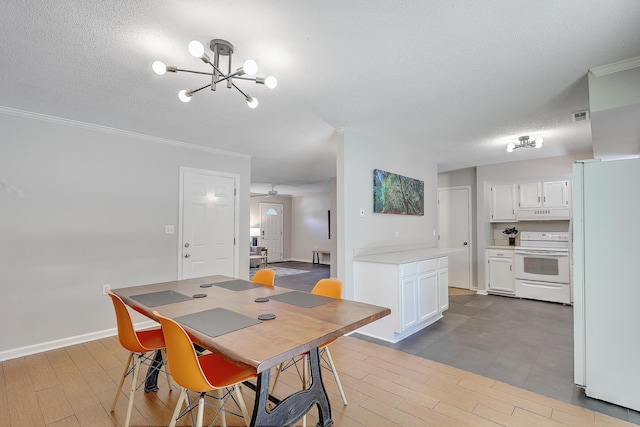 dining space with ornamental molding, a chandelier, light hardwood / wood-style flooring, and a textured ceiling